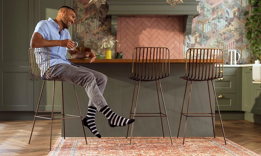 Man wearing black and grey striped bamboo blend socks