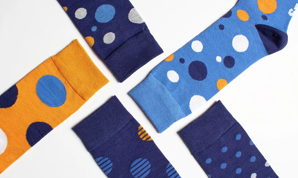 Close-up of men's patterned design navy and orange bamboo socks