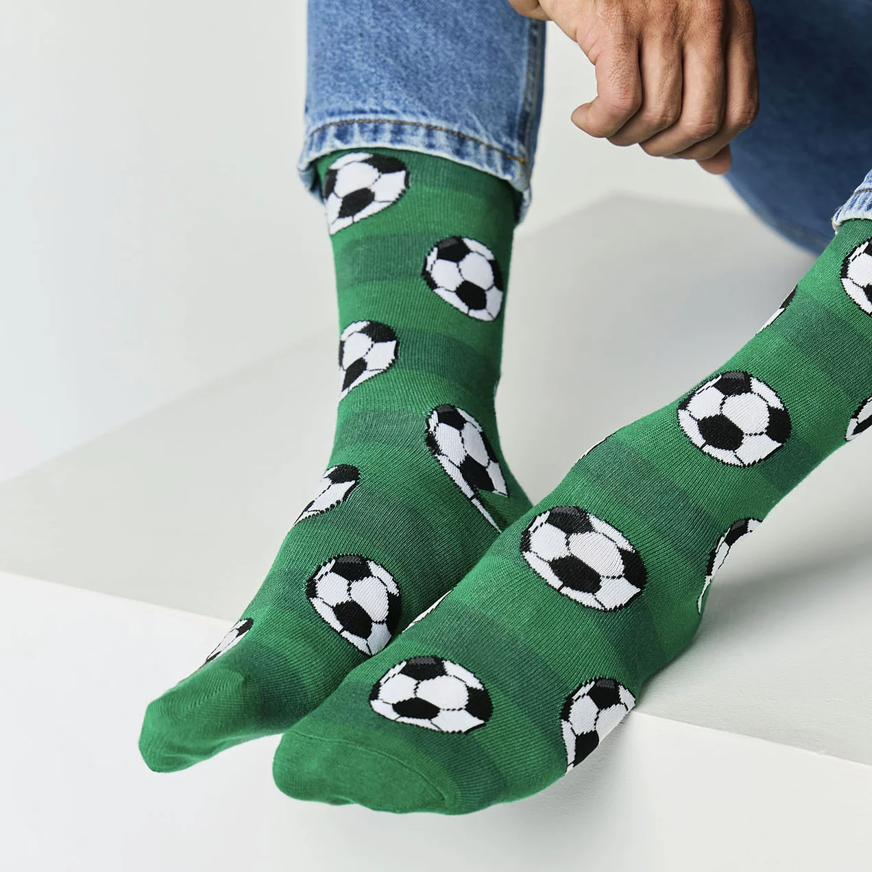 Close-up of mens green bamboo socks with football design