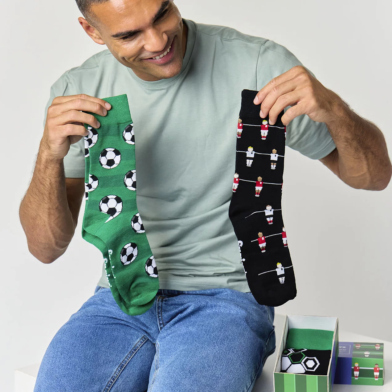 Man holding football design bamboo socks gift box