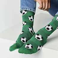 Close-up of mens green bamboo socks with football design